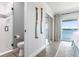 Bright bathroom with gray and white tile, modern fixtures, and a glass enclosed shower at 8115 Manasota Key Rd, Englewood, FL 34223