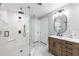 Bright bathroom featuring a glass enclosed shower, a single sink vanity, and patterned tile flooring at 8115 Manasota Key Rd, Englewood, FL 34223