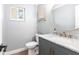 A bathroom features a window and a gray vanity at 8115 Manasota Key Rd, Englewood, FL 34223