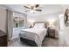 This bedroom features a ceiling fan, soft carpet, and light colored walls at 8115 Manasota Key Rd, Englewood, FL 34223