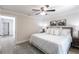 This bedroom features a ceiling fan, soft carpet, and light colored walls at 8115 Manasota Key Rd, Englewood, FL 34223