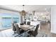 The dining area boasts a waterfront view and modern furnishings, with seating for six at 8115 Manasota Key Rd, Englewood, FL 34223