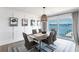 A stylish dining area with water views provides an elegant setting for meals and gatherings at 8115 Manasota Key Rd, Englewood, FL 34223