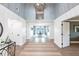 Bright entryway with high ceilings, chandelier, and an open view to the dining area and waterfront at 8115 Manasota Key Rd, Englewood, FL 34223