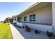 House exterior with patio, sliding glass doors, and landscaped yard and waterfront view at 8115 Manasota Key Rd, Englewood, FL 34223
