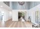 Spacious foyer features a chandelier, high ceilings, and an entryway leading to the office at 8115 Manasota Key Rd, Englewood, FL 34223