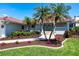 Beautiful home showcasing a covered entrance with elegant landscaping and lush greenery, enhancing its welcoming facade at 8115 Manasota Key Rd, Englewood, FL 34223