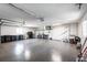 Spacious garage with sealed concrete floors, overhead lighting, and ample storage space with work area at 8115 Manasota Key Rd, Englewood, FL 34223
