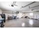 Spacious garage with sealed concrete floors, overhead lighting, and ample storage space and side door at 8115 Manasota Key Rd, Englewood, FL 34223