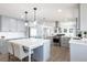 Well-lit kitchen with a center island, stainless steel appliances, and white countertops at 8115 Manasota Key Rd, Englewood, FL 34223