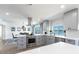 Contemporary kitchen with stainless steel appliances, a dining area, and scenic views of the water at 8115 Manasota Key Rd, Englewood, FL 34223