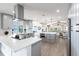 Modern kitchen with grey cabinets, stainless steel appliances, island, and views of the water at 8115 Manasota Key Rd, Englewood, FL 34223