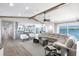 Spacious living room boasts water views, stylish furnishings, and seamless access to the open-concept kitchen at 8115 Manasota Key Rd, Englewood, FL 34223