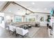 Open living room featuring beamed ceilings, comfortable seating, a wet bar, and views of the water at 8115 Manasota Key Rd, Englewood, FL 34223