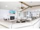 Cozy living room showcases a fireplace, wooden beam accents, and is furnished with comfortable seating at 8115 Manasota Key Rd, Englewood, FL 34223