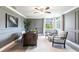 This office space has lovely gray walls, a ceiling fan and beautiful chairs and desk at 8115 Manasota Key Rd, Englewood, FL 34223