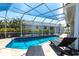 Inviting screened-in pool area with sun loungers, perfect for relaxation at 8115 Manasota Key Rd, Englewood, FL 34223