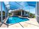 A beautiful screened pool with lounge chairs outside a waterfront home at 8115 Manasota Key Rd, Englewood, FL 34223