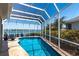 Screened-in pool with tile surround and waterfront views, perfect for relaxation and entertainment at 8115 Manasota Key Rd, Englewood, FL 34223