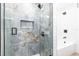This stunning shower has elegant tile, matte black hardware, and glass doors at 8115 Manasota Key Rd, Englewood, FL 34223