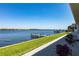 Scenic waterfront view from a home with well-manicured lawn and private dock at 8115 Manasota Key Rd, Englewood, FL 34223