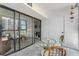 Relax on the balcony with sliding glass doors and a glass table with wicker chairs at 851 Bayway Blvd # 403, Clearwater Beach, FL 33767