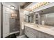 Bathroom features a vanity with a large mirror and decorative wallpaper at 851 Bayway Blvd # 403, Clearwater Beach, FL 33767