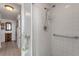 Clean, tiled bathroom with a shower, grab bars, and accessible features at 851 Bayway Blvd # 403, Clearwater Beach, FL 33767