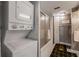 Bathroom with stackable washer and dryer, shower with door, and unique wallpaper at 851 Bayway Blvd # 403, Clearwater Beach, FL 33767