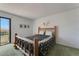 Relaxing bedroom featuring a rustic bed frame, neutral walls, and a balcony view at 851 Bayway Blvd # 403, Clearwater Beach, FL 33767