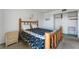 Comfortable bedroom featuring a rustic bed frame, neutral walls, and a closet at 851 Bayway Blvd # 403, Clearwater Beach, FL 33767