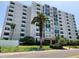 Exterior view of a modern condo building with lush landscaping, offering a stylish and welcoming entrance for residents at 851 Bayway Blvd # 403, Clearwater Beach, FL 33767