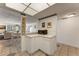 Cozy kitchen bar area featuring white cabinets, countertop and modern microwave at 851 Bayway Blvd # 403, Clearwater Beach, FL 33767