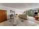 Spacious living room with tile flooring, plush seating, and access to the balcony at 851 Bayway Blvd # 403, Clearwater Beach, FL 33767