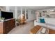 Spacious living area with mirrors, a TV, and a glimpse into the kitchen and dining spaces at 851 Bayway Blvd # 403, Clearwater Beach, FL 33767