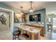 A stylish bar area with granite countertops, custom cabinets, wine rack, and two leather stools at 925 Don Juan Ct, Punta Gorda, FL 33950