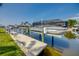 A boat sits on a lift at a private dock on a canal in this waterfront home's backyard at 925 Don Juan Ct, Punta Gorda, FL 33950