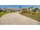Beautiful driveway leads to a well-maintained home surrounded by tropical landscaping at 925 Don Juan Ct, Punta Gorda, FL 33950