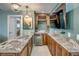 Well-lit bar area with long granite countertops, wine rack, and drink fridge at 925 Don Juan Ct, Punta Gorda, FL 33950
