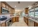 Open kitchen area with stainless steel appliances and view of the dining room and pool area at 925 Don Juan Ct, Punta Gorda, FL 33950