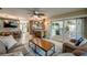 Bright living space with kitchen access, sliding glass doors, and stylish coastal furnishings at 925 Don Juan Ct, Punta Gorda, FL 33950