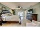 Spacious primary bedroom with access to the lanai and a dark wood dresser at 925 Don Juan Ct, Punta Gorda, FL 33950