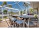 Screened-in outdoor bar and grill area overlooking the water, creating a perfect spot for entertaining guests at 925 Don Juan Ct, Punta Gorda, FL 33950
