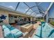 Screened-in pool area with comfortable seating and a modern fire pit, ideal for entertaining and enjoying the outdoors at 925 Don Juan Ct, Punta Gorda, FL 33950
