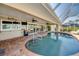 Inviting covered pool area with brick flooring, ceiling fans, and outdoor seating at 925 Don Juan Ct, Punta Gorda, FL 33950