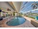 Enclosed pool area with brick flooring, outdoor seating and canal views at 925 Don Juan Ct, Punta Gorda, FL 33950