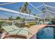 Relaxing screened-in pool area features chaise lounges and waterfront views, blending comfort and outdoor enjoyment at 925 Don Juan Ct, Punta Gorda, FL 33950