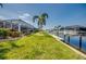 Lush landscaping and a well-maintained lawn complement the waterfront setting, with a private boat dock and lift at 925 Don Juan Ct, Punta Gorda, FL 33950
