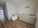 Bright bathroom featuring a standalone tub, modern vanity, and contemporary lighting at 10522 Riverside Rd, Port Charlotte, FL 33981