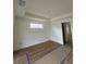 Spacious bedroom showcasing wood-style flooring, natural light, and neutral walls at 10522 Riverside Rd, Port Charlotte, FL 33981